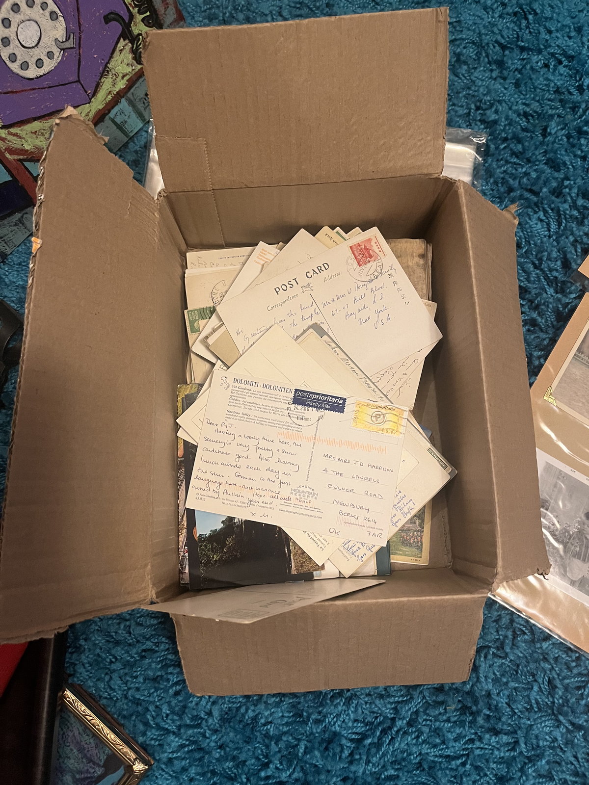 A cardboard box packed with stamped, hand-addressed envelopes standing on edge.